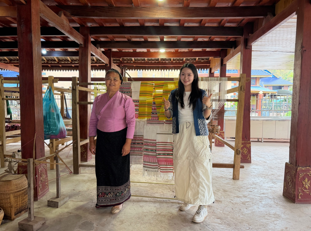 ZEWU founder meeting a textile artisan beside a working loom.